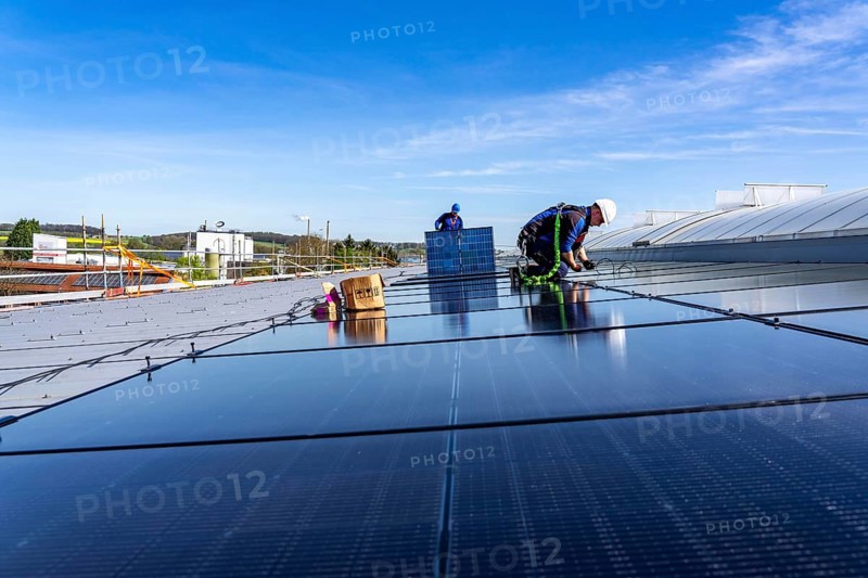 Installation of solar modules on the roof of a commercial enterprise, over 400 photovoltaic modules are installed on the roof, North Rhine-Westphalia, Germany, Europe