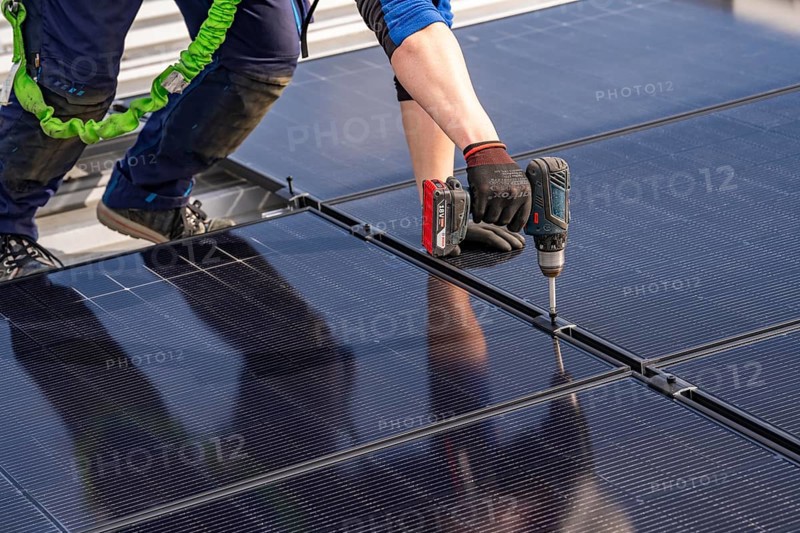 Installation of solar modules on the roof of a commercial enterprise, over 400 photovoltaic modules are installed on the roof, North Rhine-Westphalia, Germany, Europe