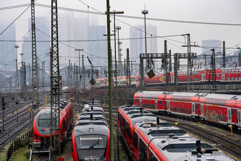 Railway tracks with regional trains, after freezing rain, in front of Frankfurt main station, skyline in the fog, Hesse, Germany, Europe