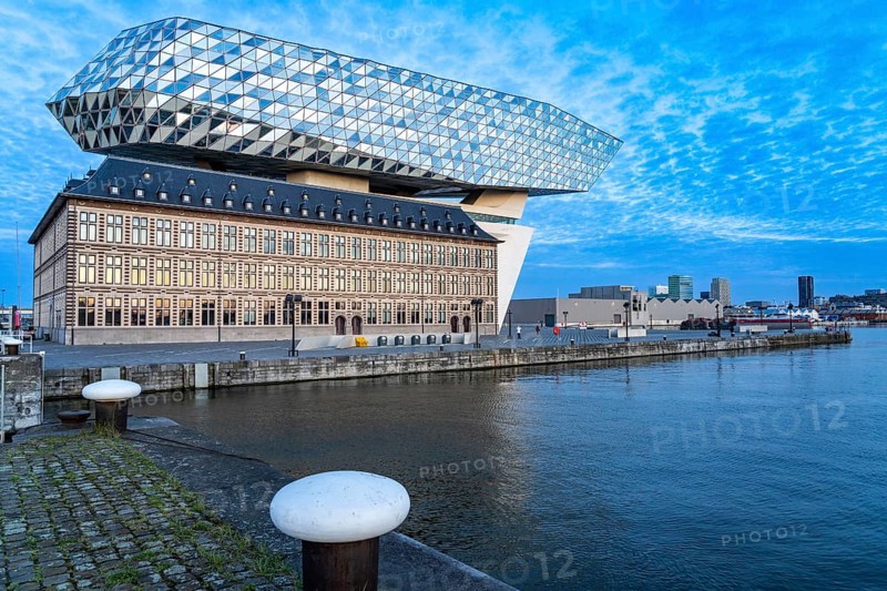 The Antwerp Port Authority building, Havenhuis, former fire brigade barracks in the harbour, renovated and with an attached glass structure in the shape of a ship's hull, administrative headquarters of the Antwerp Port Authority, designed by Zaha Hadid, Antwerp, Flanders, Belgium, Europe