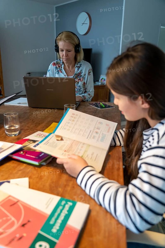 Homeschooling, during the lockdown in January 2021, children learn at home for school, their mum is in the home office and works on the laptop with video chat, school closures, distance learning, effects of the corona crisis in Germany