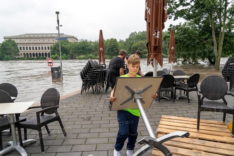 High water on the Ruhr, after long heavy rainfall the river left its bed and flooded the countryside and villages, the highest water level ever recorded, Flooded Ruhr promenade in Mülheim, caterers bring their furniture to safety, Mülheim an der Ruhr, North Rhine-Westphalia, Germany, Europe
