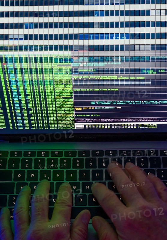 Symbolic image hacker, cyber attack on public buildings, administrations, institutions, town hall, authorities, digital blackmail, data theft, online criminal offences, cyber extortion, ransomware
