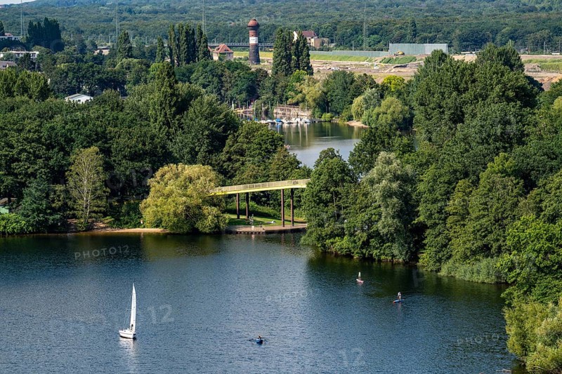 The Sechs-Seen-Platte, a local recreation area in the south of Duisburg, near the Wedau district, 6 former gravel pits, view over the Wolfssee, yellow bridge, behind it the Masurensee and the former railway area, construction site for the 6 Seen Wedau project, North Rhine-Westphalia, Germany, Europe
