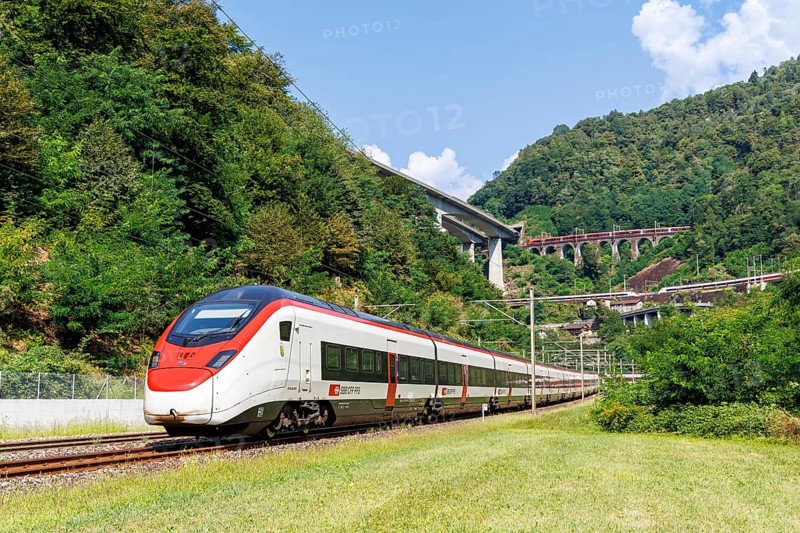 Railway passenger train type Stadler Giruno of the Swiss Federal Railways SBB on the Gotthard railway in the Alps in Giornico, Switzerland, Europe