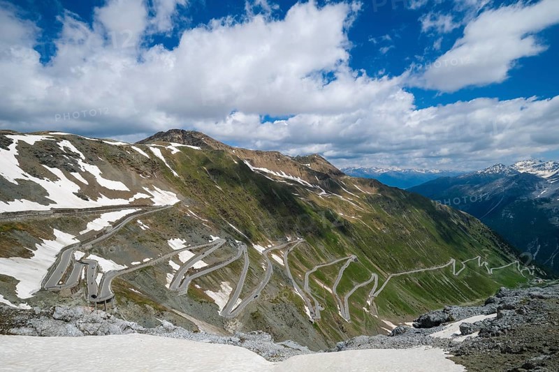Stilfserjoch, Vinchgau, South Tyrol, Italy, Stilfser Joch pass road, the ascent over the tight bends, the narrow hairpin bends is a popular destination for cyclists, motorcyclists and motorists, snow-covered mountain landscape of the Swiss Alps in the background, Europe