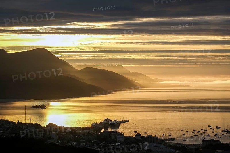 Ushuaia, Tierra del Fuego, Argentina, sunrise over the Beagle Channel, the Beagle Channel is a natural waterway at the southern tip of South America that connects the Atlantic Ocean with the Pacific Ocean. Ushuaia is the southernmost city in the world, the end of the world. Behind mountain range on the island of Navarino in Chile, Dientes de Navarino, South America