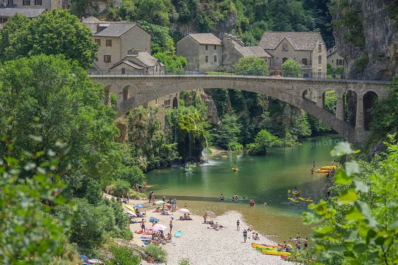 View of the village of Saint Chely with bridge and waterfall, Gorges du Tarn Causses, Département Lozère, France, Europe