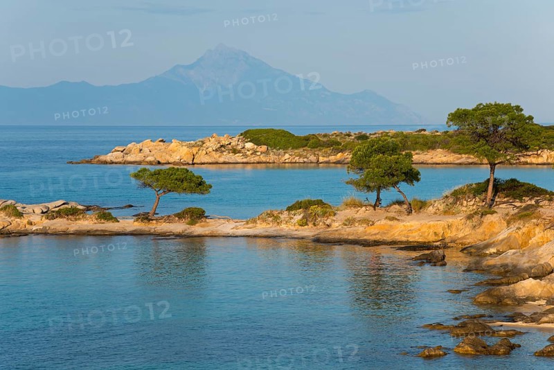 Picturesque bay with tree-covered rocks and mountain views, Karidi beach, Karydi, Mount Athos in the background, Vourvourou, Sithonia, Halkidiki, Central Macedonia, Greece, Europe