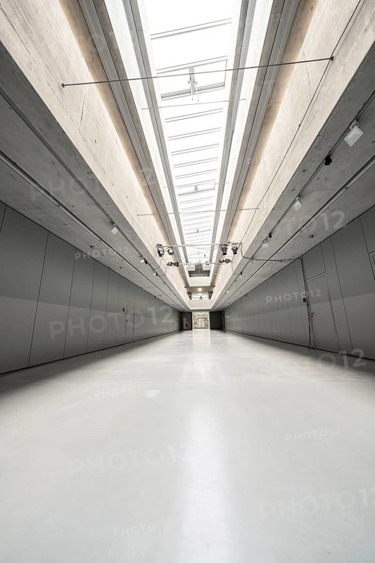 An ultra-modern, empty space with high ceilings and glass and concrete elements that create a minimalist aesthetic, University of Stuttgart, Germany, Europe