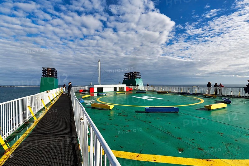 Passengers on sun deck, helipad on a ferry between Ireland and Wales, spring clouds, Ireland, Europe