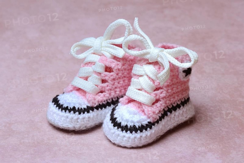 Baby shoes with pink background, handmade