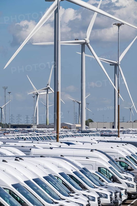 Storage area for new cars in the port of Vlissingen-Oost, vehicles are temporarily stored on over 100 hectares to ship them from Europe to the United Kingdom, Ford cars, others such as models from the Chinese car manufacturer BYD are delivered from here in Europe, wind farm, Netherlands