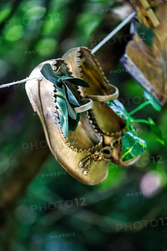 Children's shoes, shoes hanging on a washing line in the woods, vintage, decoration, Lost Gardens of Heligan, Cornwall, England, Great Britain