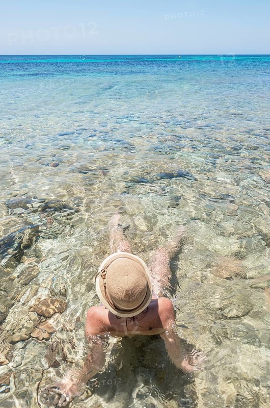 Woman relaxing in the cliear water of Formentera island, Formentera, Balearic Islands, Spain, Europe