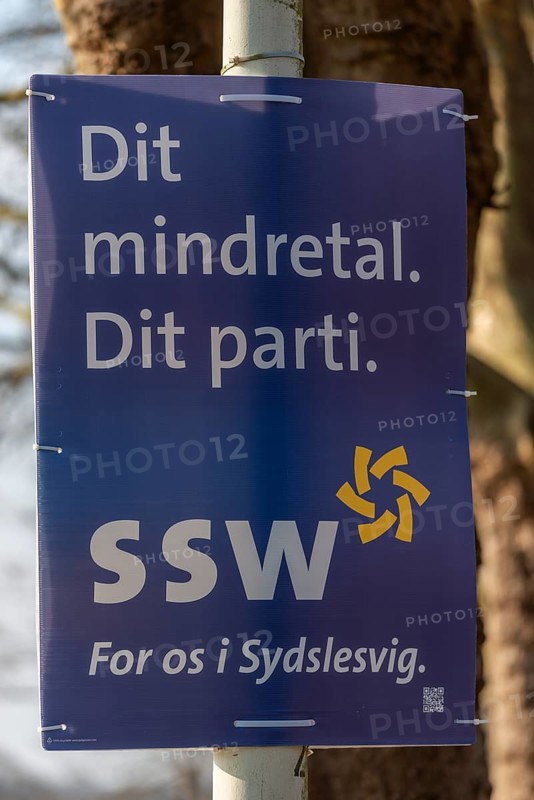 The South Schleswig Voters' Association SSW also advertises in Danish on its posters in Schleswig-Holstein, advertising the political parties for the 2025 general election, translation reads, Deine Minderheit. Your party, SSW for us in South Schleswig. Poster in Kiel-Holtenau, Germany, Europe