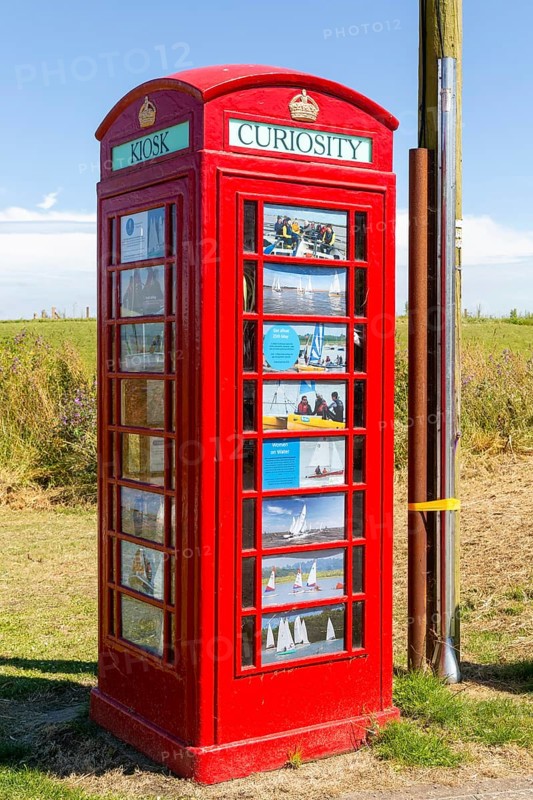 Red K6 telephone box repurposed as local curiosity information booth, Felixstowe Ferry, Suffolk, England, Uk