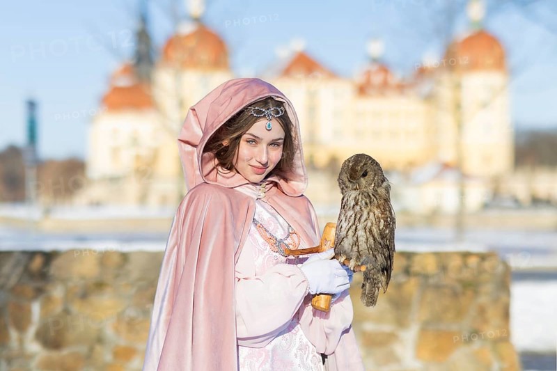 This year, the most popular fairytale film of all time is celebrating a special anniversary. At Moritzburg Castle, one of the film's locations, the exhibition on the cult film Three Hazelnuts for Cinderella is opening for the twelfth time - with an anniversary-worthy supporting programme and special exhibition. Model Tamara Kretschmer once again slips into the coveted role of the legendary Cinderella with the ball gown, here with the owl, Moritzburg, Saxony, Germany, Europe