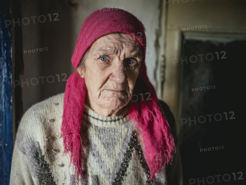 Lena, 70 years old, cares for her severely disabled granddaughter Lena, 18 years old. The family was unable to leave the village for financial reasons and because of Lena's disability, they only survive thanks to humanitarian aid, Voloska Balakliia, Kharkiv Oblast, Ukraine, Europe