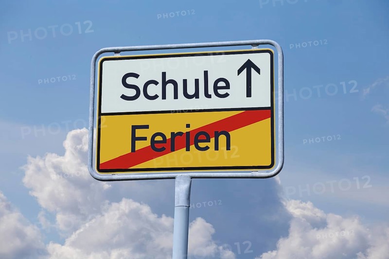 School start symbol: Town exit sign with the terms HOLIDAYS and SCHOOL (Composing)