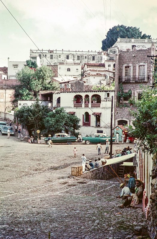 People and taxis at the Plaza bus stop, Hotel Colonia, Taxco, Guerrero state, Mexico, 1961, Central America
