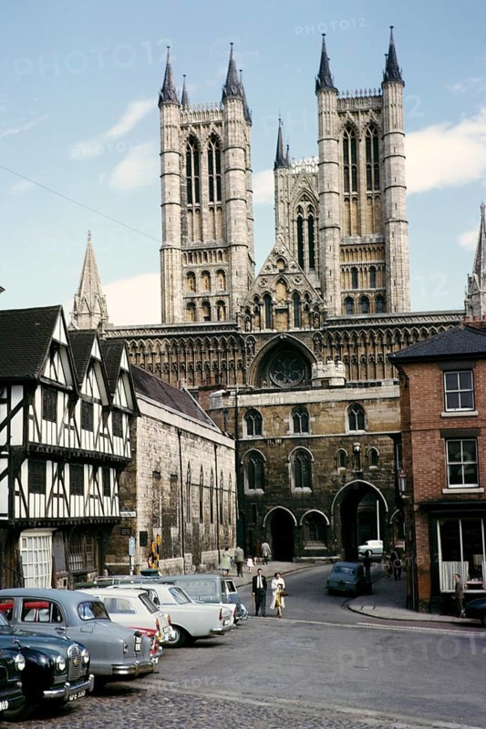 People and cars on Castle Hill square near Lincoln Cathedral, Lincolnshire, England, 1963