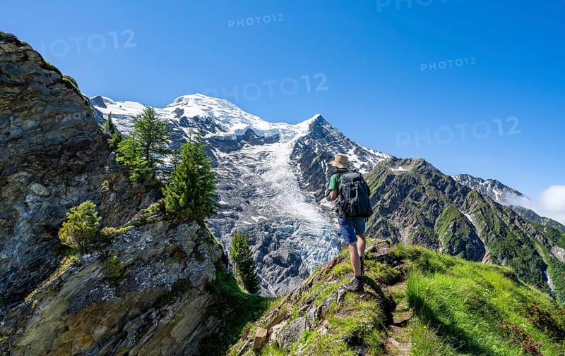 Mountaineer on a hiking trail in front of mountain landscape with glacier, view of glacier Glacier de Taconnaz, hike La Jonction, Chamonix, Haute-Savoie, France, Europe