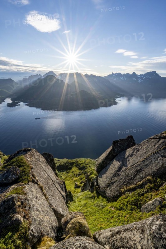 View of Fjord Raftsund and mountains in the evening light, sun star, view from the top of Dronningsvarden or Stortinden, Vesterålen, Norway, Europe