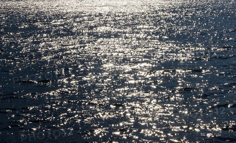 Sunbeams reflect glittering on water surface with high waves, Abstract background, Graphic elements, Mondsee, Salzkammergut, Austria, Europe