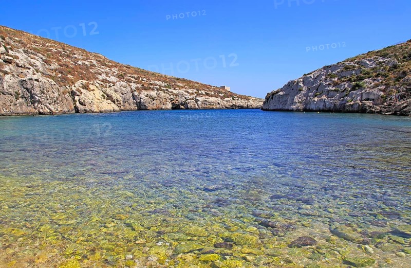 Shoreline clear blue sea water, Mgarr ix-Xini coastal inlet, island of Gozo, Malta, Europe