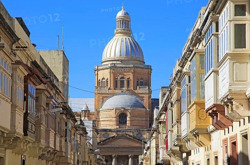 Traditional houses with balconies dome of Paola parish church, Tarxien town, near Valletta, Malta, Europe