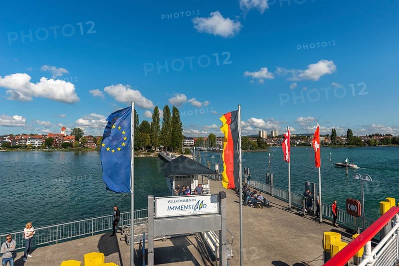 Immenstaad on Lake Constance, townscape, jetty, flags, name plate, blue sky, Baden-Württemberg, Germany, Europe