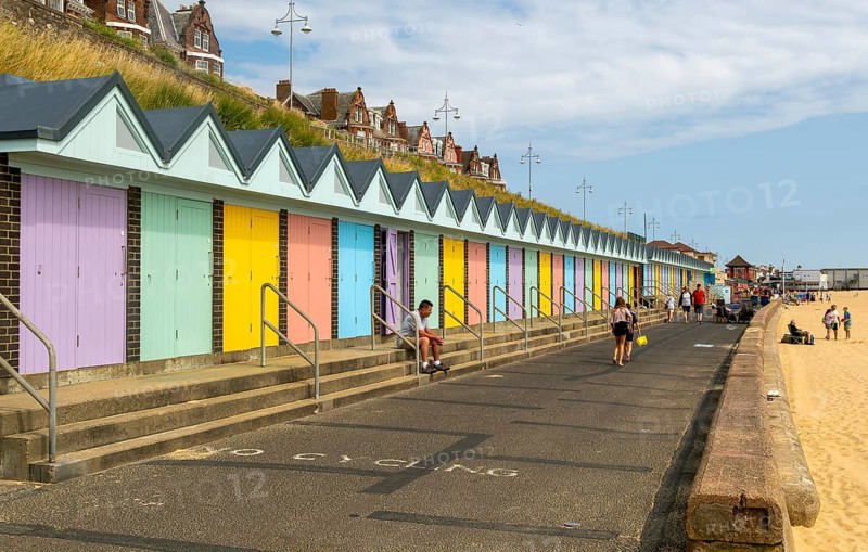 Colourful beach huts and promenade footpath, South Beach, Lowestoft, Suffolk, England, UK