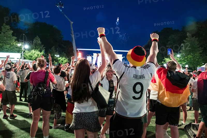 Fans cheer after the 1:0 win for Germany in the fan zone at the Brandenburg Tor during the round of 16 match between Germany and Denmark at the European Football Championship, Berlin, 29 June 2024