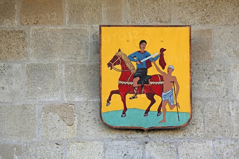 City coat of arms at the Porte de la Gardette, city gate, detail, Saint Martin, saint, horse figure, beggar, share, give, take, care, charity, Christian, Aigues-Mortes, Gard, Camargue, Provence, France, Europe