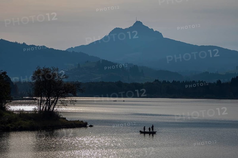 Lake Gruentensee, people fishing from a boat, Mt. Gruenten in the back, Wertach, Bavaria, Germany, Europe