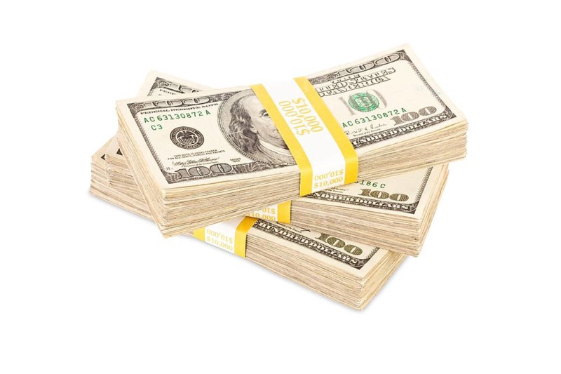 Ten thousand dollar stacks of one hundred dollar bills isolated on white