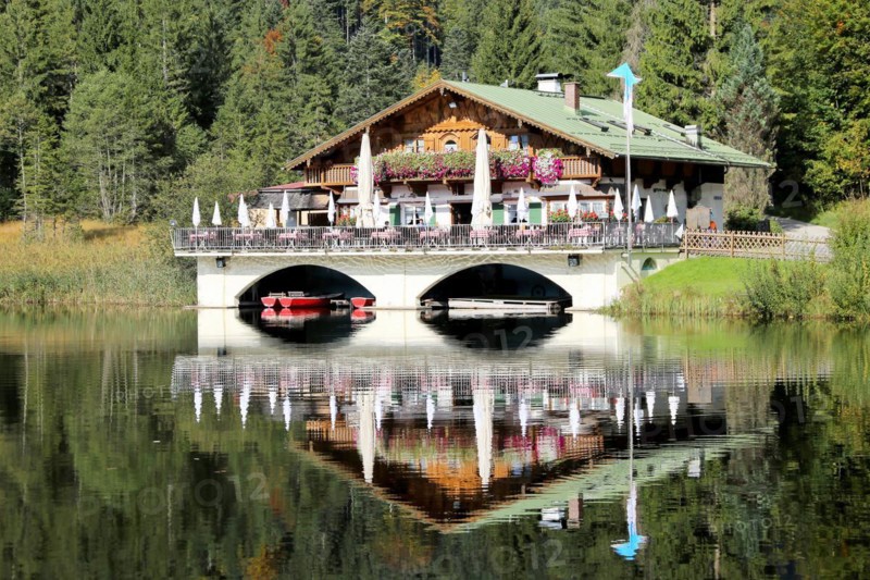 The picturesque Pflegersee lake near Garmisch, with the mountain inn in the background