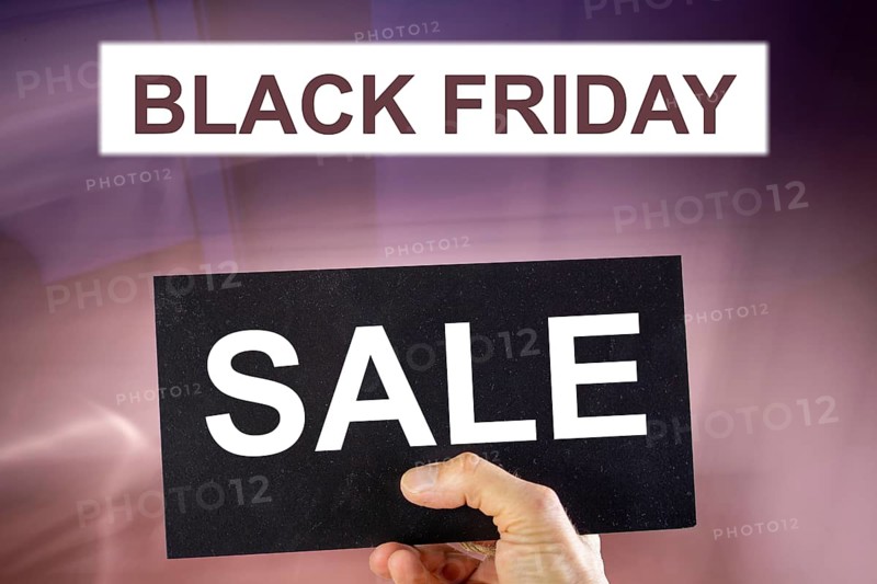 Black Friday symbol: BLACK FRIDAY lettering and a sign with the word SALE against an abstract background (Composing)