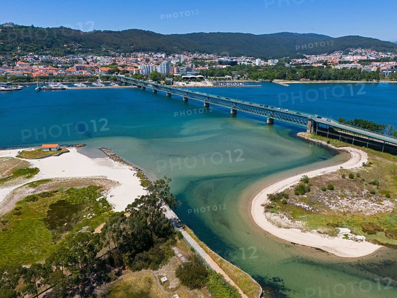 View of a city on the water with a large bridge crossing an estuary, surrounded by mountains and beaches, aerial view, Ponte Eiffel, bridge by Gustave Eiffel, Lima River, Viana do Castelo, Portugal, Europe