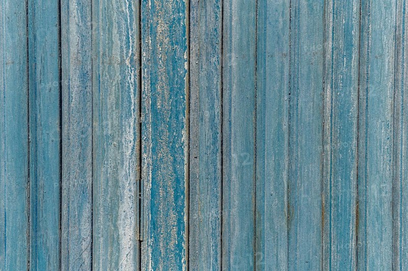 Garage door boards stained blue with worn paint. Brittany France