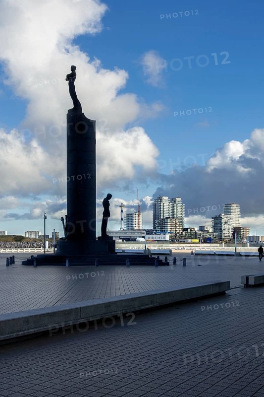 National Monument to the Sailors, Nationaal Monument voor de Zeelieden silhouetted against the Oosteroever quarter in Ostend, West Flanders, Belgium, Europe