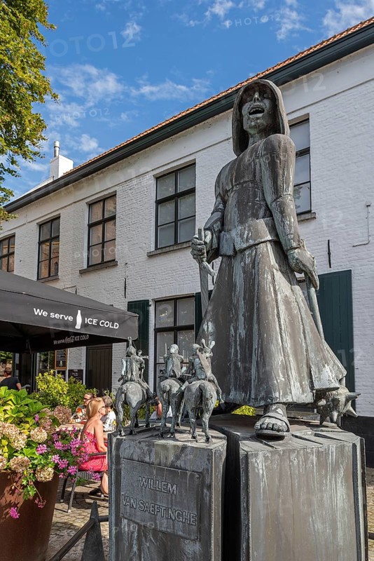 Statue of Willem van Saeftinghe, lay brother and Flemish folk hero in the village Lissewege near Bruges in summer, West Flanders, Belgium, Europe