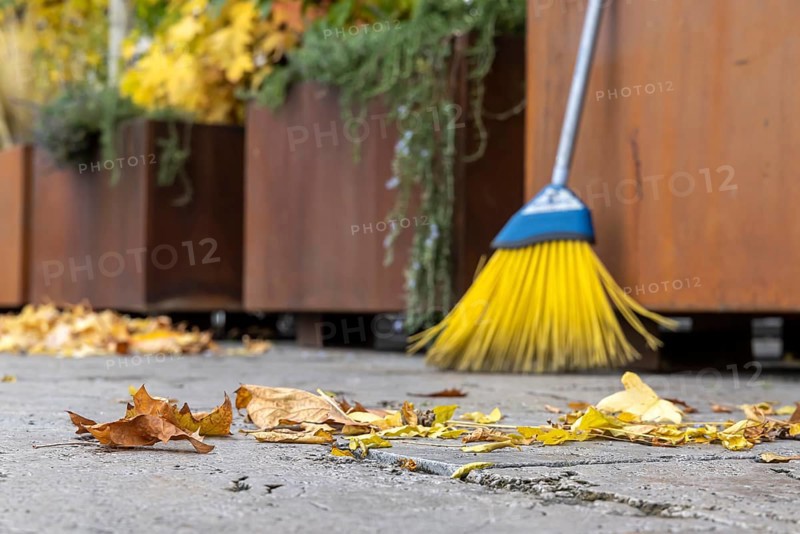 Leaves are falling from the trees. Autumn is the time for brooms to sweep the leaves off the pavement. Sweeping week in Stuttgart, Baden-Württemberg, Germany, Europe