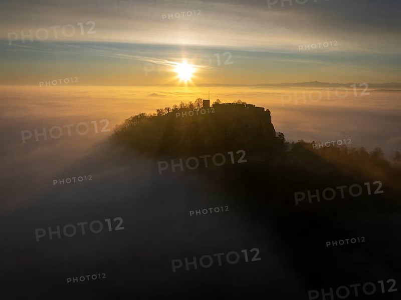 Aerial view of the Hegau volcano Hohentwiel with the upper fortress ruins as a silhouette at sunrise, rising out of the fog during an inversion, district of Constance, Baden-Württemberg, Germany, Europe