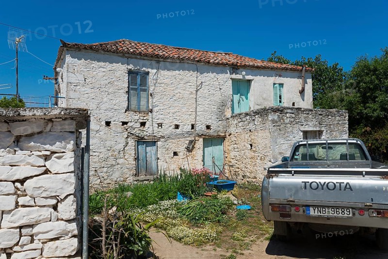 Old stone house with a Toyota pickup truck in the foreground in a rural setting, Taktikoupolis, Attica, Peloponnese, Greece, Europe