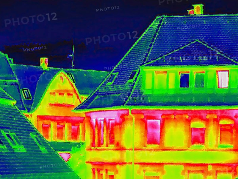 Apartment block, facade of a residential building with windows. Thermal image or thermography, symbol photo, interpolated. Germany