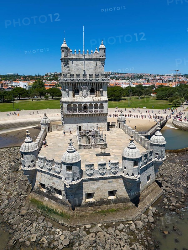 A tower near a city on the shore with blue water, sky and tourist visitors, aerial view, Torre de Belém, World Heritage Site, Belem, Bethlehem, Lisbon, Lisboa, Tagus River, Portugal, Europe