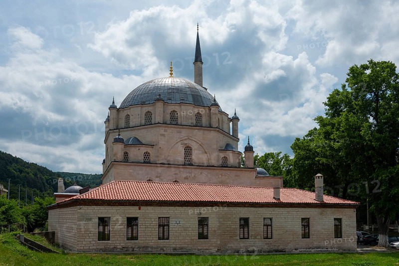 View of a mosque with dome and minaret, flanked by trees under a cloudy sky, Tombul Mosque, Sherif Halil Pasha Mosque, Serif Halil Pasa Mosque, Serif Halil Pasa Camii, important Ottoman building, Shumen, Shumla, Unesco World Heritage Site, Bulgaria, Europe