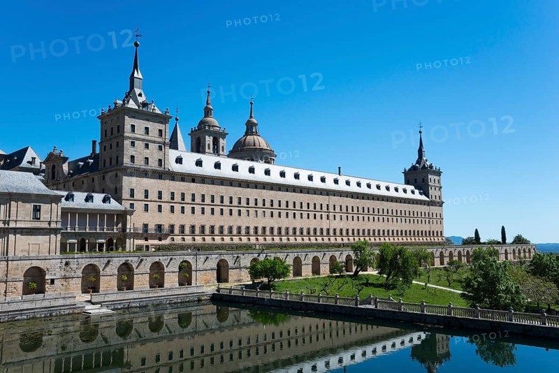 Historic stone monastery with reflection in the water and clear sky, Real Sitio de San Lorenzo de El Escorial, Royal Seat of St Lawrence of El Escorial, palace and monastery complex, San Lorenzo de El Escorial, Madrid, Spain, UNESCO World Heritage Site, Europe